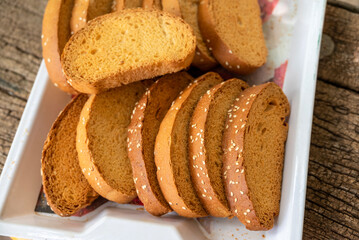 Crispy rusk, Biscuits cake rusk over wooden background , a crunchy snack infused with traditional spices, perfect for tea or coffee. A delightful treat for your mornings or tea time