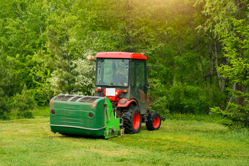 Cutting grass with a tractor in a lush green landscape during daylight
