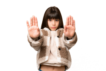Little girl over isolated green chroma key background making stop gesture and disappointed