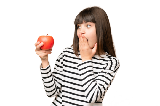 Little girl with an apple over isolated chroma key background with surprise and shocked facial expression
