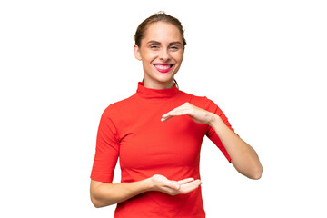 Young caucasian woman over isolated background holding copyspace imaginary on the palm to insert an...