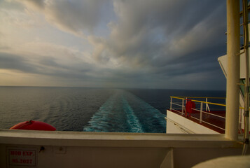View of the stern of a merchant ship at sea in the morning