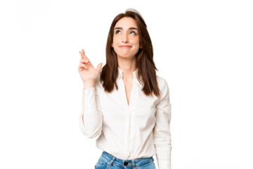 Young caucasian woman over isolated chroma key background with fingers crossing and wishing the best