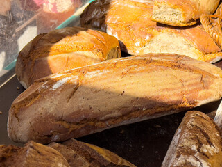 Assortment of fresh artisan bread loaves at market display
