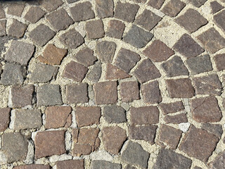Intricate cobblestone path texture with natural stone pattern and sand grout