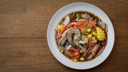 Classic Thai Somtam (Thai Somtam) served on a wooden table. Famous and refreshing menu The concept of authentic Thai food is very popular