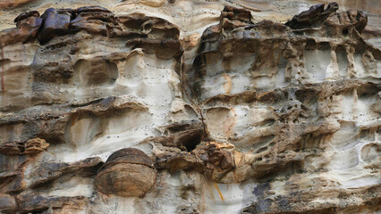 Colorful rock formations showcase the intricate patterns and textures of nature in the coastal landscape during midday light