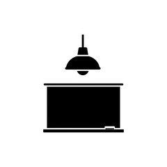 Light fixture mounted above blackboard illuminating workspace