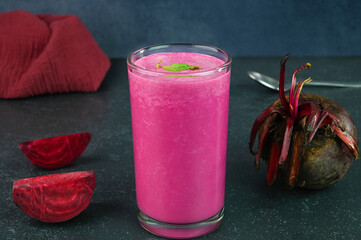 Serving beetroot smoothie in a glass cup.