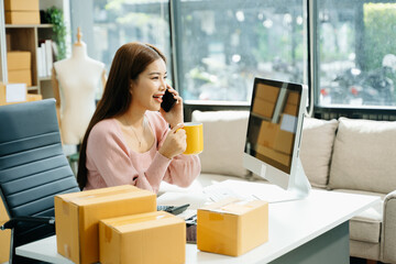 Young businesswoman managing online sales and shipping from a modern home office.