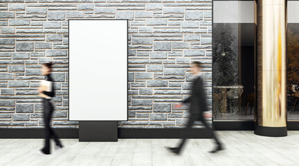 Vertical blank advertising billboard on stone wall outside business center with blurred people...