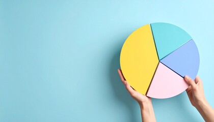 hand holding a colorful pie cart on blue background