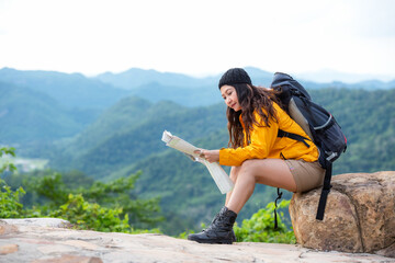 Woman travel hiker adventure on mountain nature landscape.  Asia people lifestyle tourist girl backpack sitting with map to find directions explore and camping outdoors for relax summer time