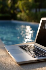 Laptop working remotely by the swimming pool