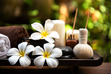 Spa beauty massage healthy wellness background. Spa Thai therapy treatment aromatherapy for body woman with flower Plumeria nature candle for relax summer time. Lifestyle and Cosmetic Concept