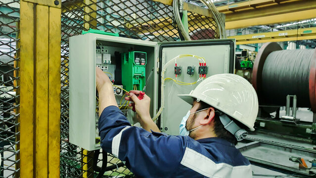 Electrician engineer works to repair a control panel