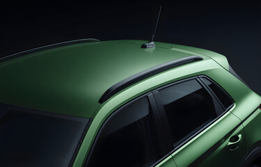 Close-up view of a green car roof with black matte antenna and textured plastic trim under studio lighting, isolated against a dark background for advertising, branding or design templates