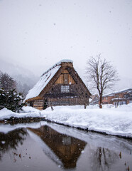 Traditional House in Shirakawago during winter.Traditional Houses of The Historic Villages of Shirakawa-go and Gokayama( Gassho Zukuri Folk Village) With Reflection at Winter Snow Night, Japan.