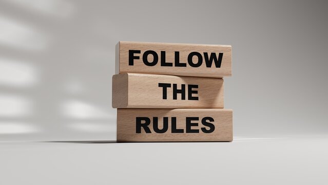 Follow the rules symbol. Concept words Follow the rules on wooden blocks. Business and follow the rules concept. Copy space.3D rendering on white background.