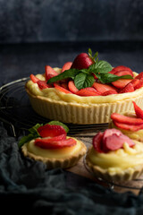 Homemade Strawberry Tart with Cream and Mint on Rustic Background