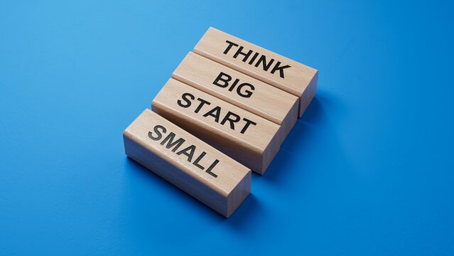 Think big start small symbol. Concept words Think big start small on wooden blocks.Business and Think big start small concept. Copy space.3D rendering on blue background.