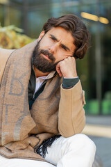 Sad unhappy Indian young businessman tourist thinks over life concerns, suffers from unfair...