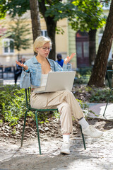 Upset young woman tourist using laptop computer typing browsing, loses becoming surprised sudden...