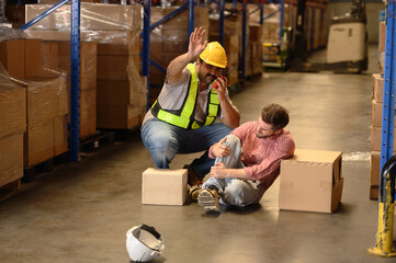 First aid support accident at work of worker at factory. Male worker has an accident on the floor...