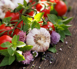 Fresh vegetables and aromatic herbs on wooden table, close up view