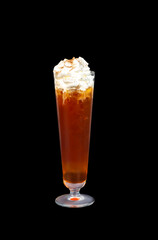 Non-alcoholic cocktail with crushed ice, cherry topping and orange jui