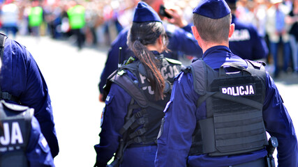 Police sign - logo on the back of the police uniform. Policja © Grand Warszawski