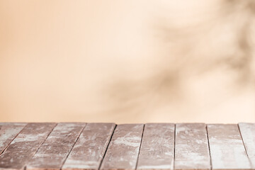 Vintage wooden tabletop with a warm beige blurred background creating a soft rustic setting ideal...