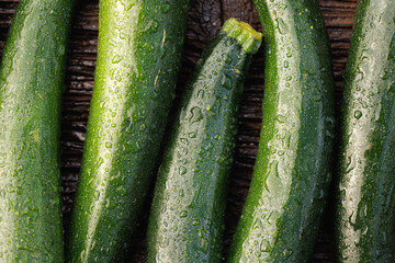 Close-up view of fresh several zucchini on a wooden background