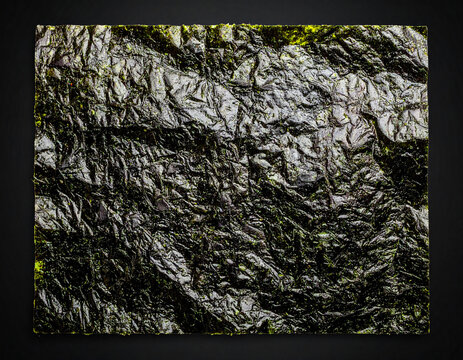 a sheet of nori isolated on a black background