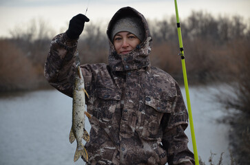 Naklejka premium Woman fishing with a trophy pike