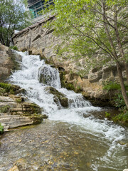 A foamy, murky river flows through a rocky landscape. High quality photo