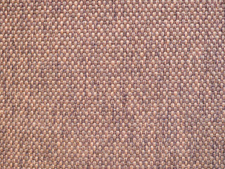 Textured woven fabric in neutral tones showcases intricate detailing and craftsmanship in a close-up view
