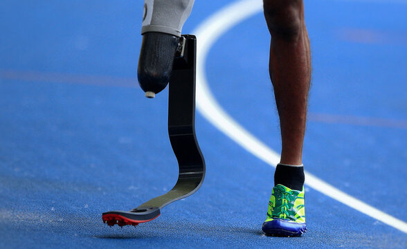 Disabled male athlete with leg prosthesis. Paralympic Sports Concept - Powered by Adobe