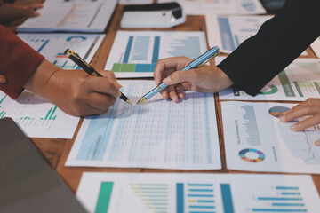 Group of business people brainstorming in analytical plan meeting Calculate the numbers obtained...