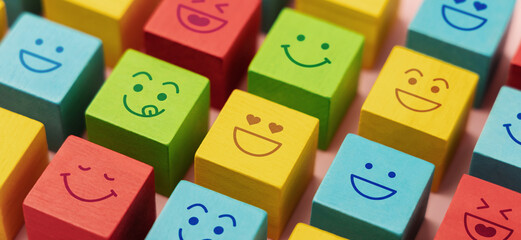 Mind and mental Health Concepts. Happy Community. World Happiness, International Smiling Day. Group of Smiling Emoticon Diversity Face on Multi-colour Cube. Closeup shot