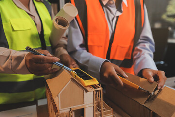 Engineers are helping to design work on blueprints and collaborate on structural analyzing of...