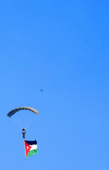 Paratroopers land in an air show to mark Jordan's Independence Day.