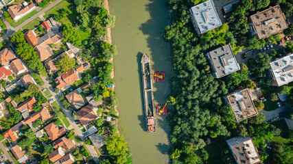 Naklejka premium Aerial view of river, canal is being dredged by excavators