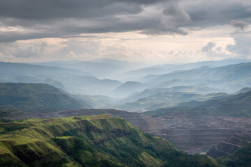 Naklejka premium stunning open pit mine in zambia set against dramatic storm clouds rich color tones