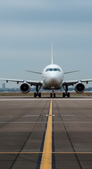 Obraz premium Airplane On Runway Under Sky Awaiting Flight For Transportation