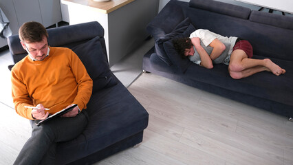 Services of a competent psychologist. A psychoanalyst in an orange sweater and glasses is looking...