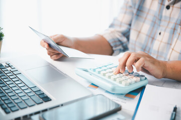 Business hands holding saving account passbook with calculator, account and saving concept. finance...