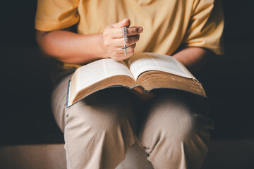 Christian woman reading bible in ancient Catholic temple. Reading Holy Bible in temple. Concept for...