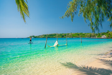 Active lifestyle Travel people with SUP in hand enjoy summer vacation on tropical beach 