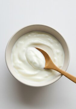 Plain Yogurt in Bowl with Wooden Spoon a Healthy Breakfast Photo